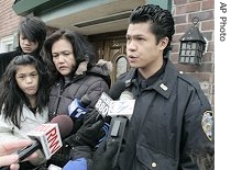 Ceasar Borja answers questions during a news interview as his mother, Eva, sister and brother, look outside funeral home, 25 Jan 2007 
