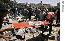 Palestinians carry body parts covered in the flag of Hamas' Executive Force as other search for bodies after an Israeli missile strike on a Hamas base killed four militants in the Zeitoun neighborhood in Gaza City, Saturday, 26 May 2007
