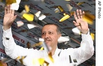 Recep Tayyip Erdogan salutes supporters of his Justice and Development Party during election rally