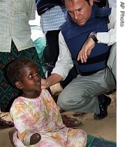 UN Humanitarian Coordinator for Somalia Erick Laroche chats with handicapped girl in an internally displaced camp situated on the outskirts of Mogadishu, 1 Aug. 2007