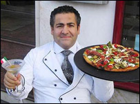 Domenico Crolla with a cocktail and a pizza