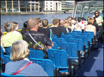 Passengers on the catamaran cruise along the river Thames