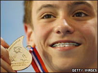 Tom Daley shows off his medal