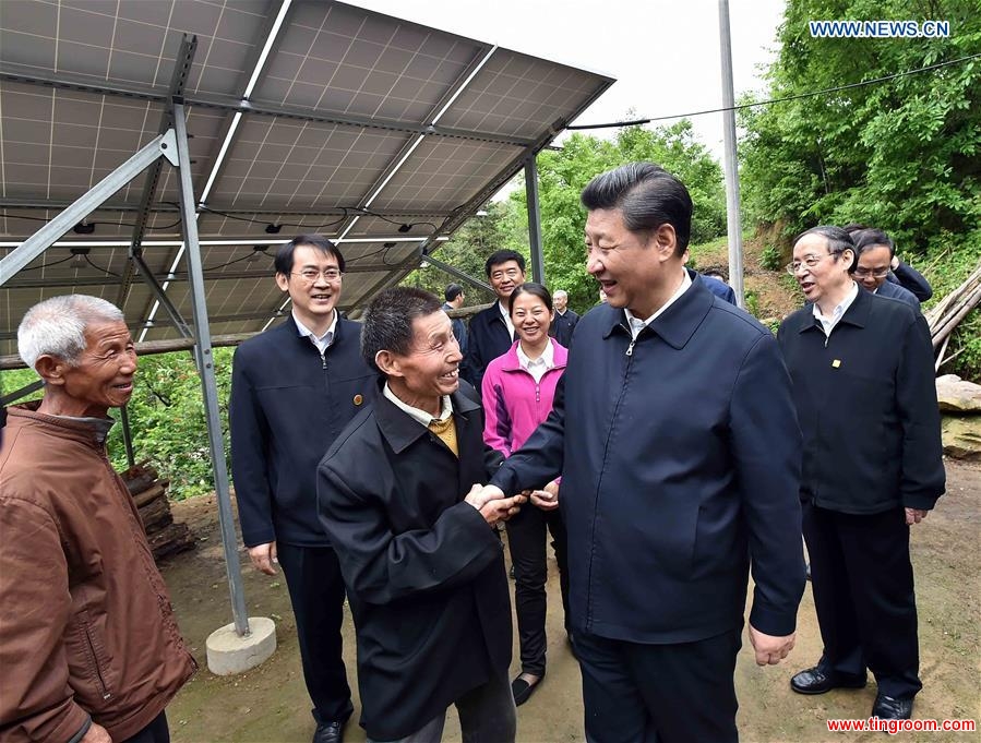 Chinese President Xi Jinping (R front) inspects the solar power station installed under a poverty alleviation project in Dawan Village of Huashi Township in Jinzhai County, Liuan City, east China