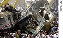 People gather at the site of a train crash in rail station of Qalyoub, north of Cairo, Egypt, Monday, Aug. 21, 2006