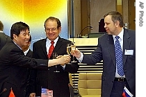 Yanhua Liu, left, Raymond Orbach, center, Vladimir Travin, right, make toast at end of signing ceremony 