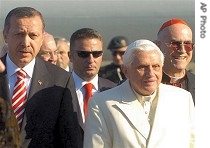 Pope Benedict XVI, accompanied by Vatican Secretary of State Cardinal Tarcisio Bertone, right, is welcomed by Turkish Prime Minister Recep Tayyip Erdogan, left, upon his arrival 28 Nov. 2006