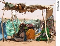 Darfur refugees, sitting under a make-shift shelter in this derelict section of Es Sallam camp say they have been waiting nine months to be relocated to decent shelters, 25 Mar 2007 