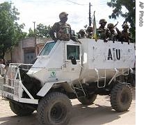 A.U. peacekeepers from Uganda patrol on an armored vehicle in Mogadishu, 14 May 2007