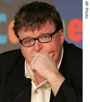 American director Michael Moore pauses before answering questions at a press conference for the film 'Sicko,' at the Cannes, southern France 19 May 2007