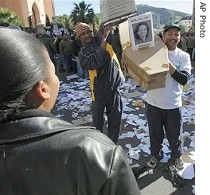 Public sector workers march with a mock coffin carrying a portrait of Frazer Moleketi, S. Africa's Minister for Public Service