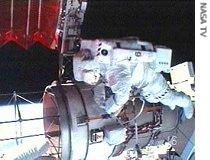Spacewalker Steve Swanson helps with the retraction of a solar array during the mission's second spacewalk, 14 Jun 2007