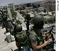 Palestinian militants from Al Aqsa Martyrs Brigades, linked to Fatah Movement, stand on roof of Palestinian parliament building after taking it over in Ramallah (16 Jun 07)