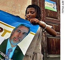 A girl holds up an electoral poster featuring a picture of former President Xanana Gusmao in Dili, 25 June 2007