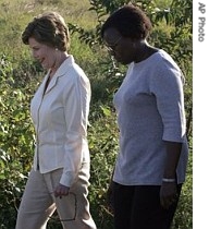 US first lady Laura Bush, left, walks with Ivone Rungo, Director of National Malaria Control Program, 27 June 2007