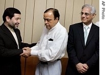 Indian petroleum minister Murli Deora (center) shakes hand with Iran's special representative of Ministry of Oil Ghanimi Fard (l) before the start of a meeting, in New Delhi, 29 Jun 2007