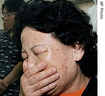 Relatives of South Koreans kidnapped in Afghanistan react while they deliver a speech for the hostages in Seoul, South Korea, 26 July 2007