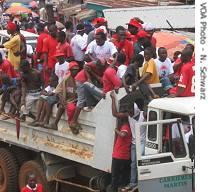 Sierra Leone election campaign rallyers on trucks