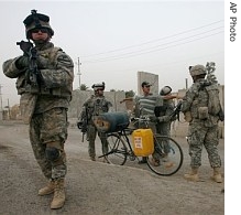 An Iraqi man is searched by US Army troops in Baghdad, Iraq, 4 Aug. 2007