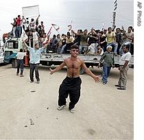 A man gestures as he celebrates with others standing on a truck the end of fighting in the Nahr el-Bared Palestinian refugee camp, in the northern city of Tripoli, Lebanon, 03 Sept 2007