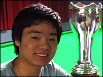 Ding Junhui celebrates winning the UK Championship