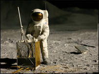 An astronaut stands on the surface of the Moon